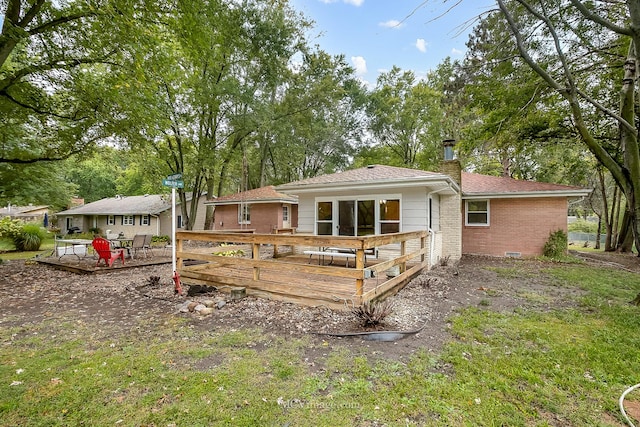 rear view of property featuring a deck