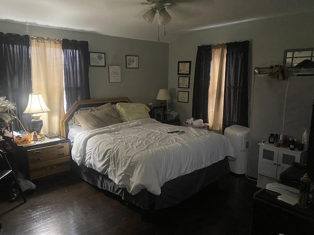 bedroom featuring ceiling fan and dark wood-type flooring