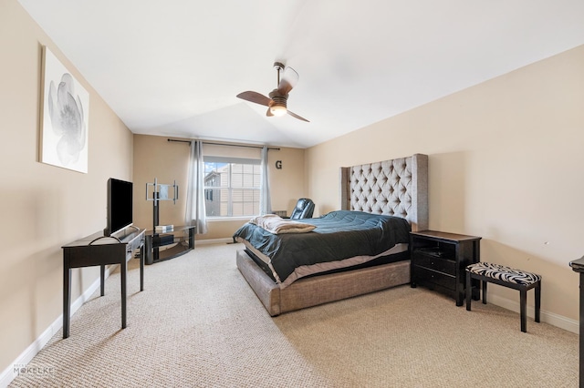 bedroom featuring baseboards, light colored carpet, and a ceiling fan