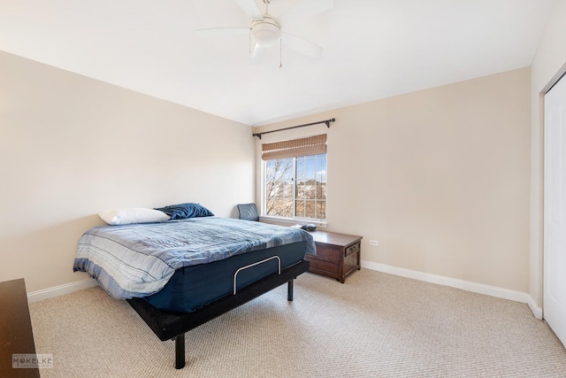 bedroom featuring baseboards, light carpet, and a ceiling fan