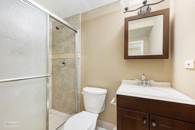 bathroom with vanity, toilet, and a stall shower