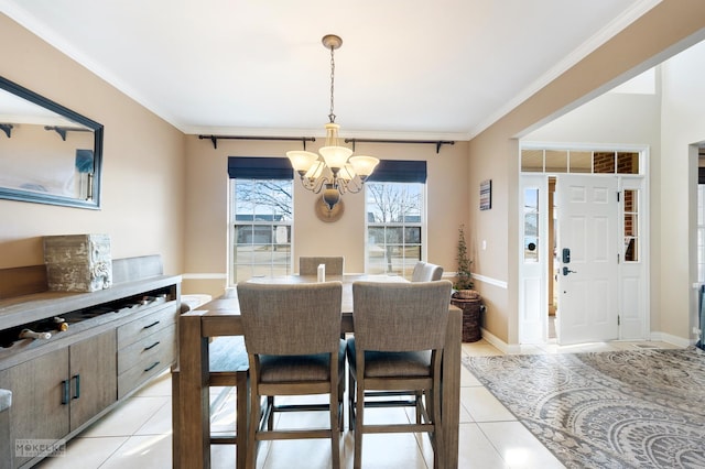 dining room featuring a notable chandelier, light tile patterned floors, baseboards, and ornamental molding