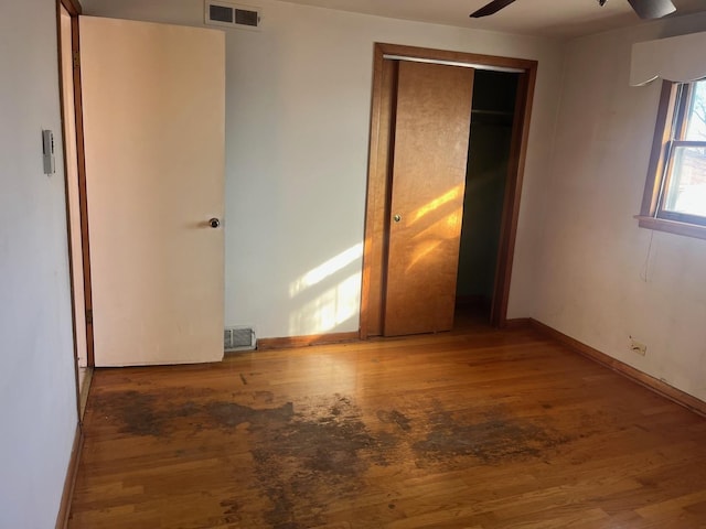 unfurnished bedroom featuring a closet, ceiling fan, and hardwood / wood-style flooring