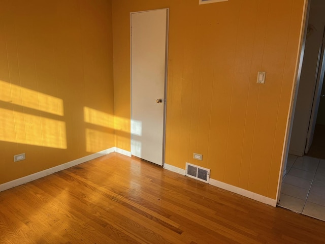 unfurnished room with wood-type flooring