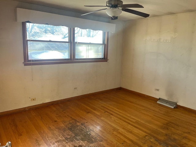 spare room with ceiling fan and hardwood / wood-style floors