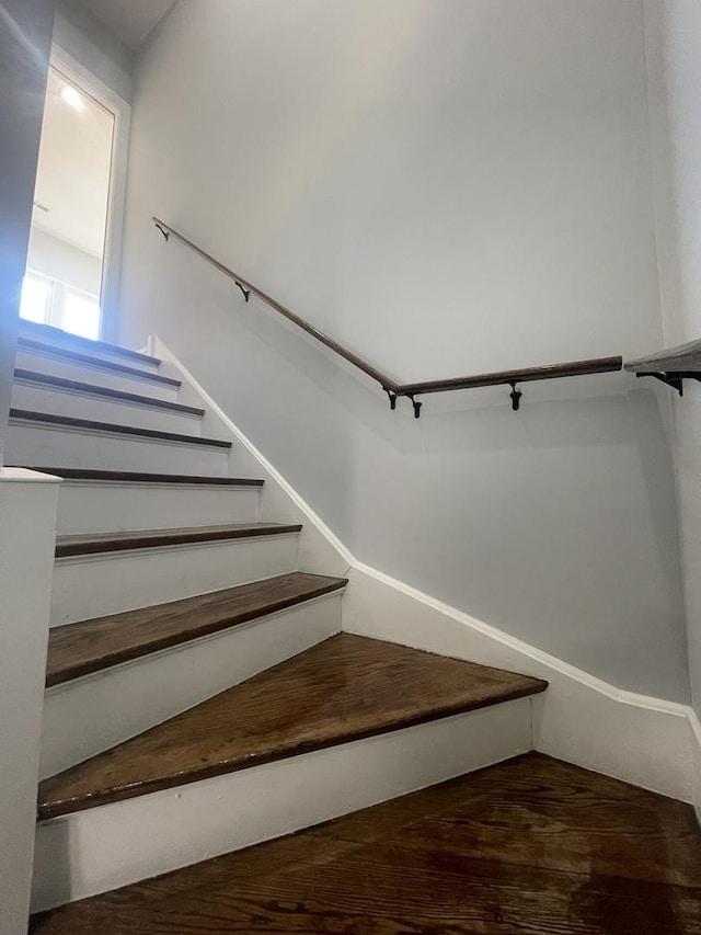 staircase with hardwood / wood-style floors