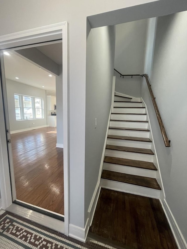 stairway with hardwood / wood-style floors