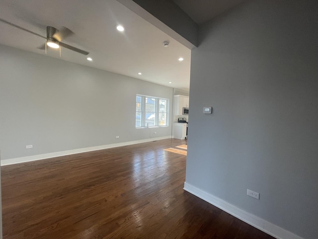 empty room featuring dark hardwood / wood-style flooring and ceiling fan