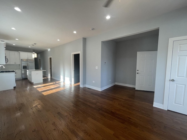 unfurnished living room featuring dark wood-type flooring