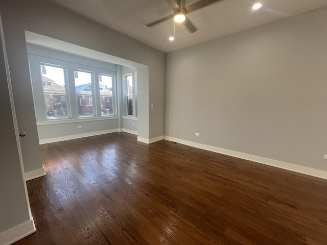 spare room with dark hardwood / wood-style floors and ceiling fan