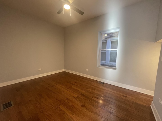 unfurnished room featuring dark hardwood / wood-style floors and ceiling fan