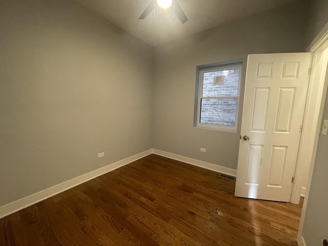 unfurnished room with dark hardwood / wood-style flooring and ceiling fan