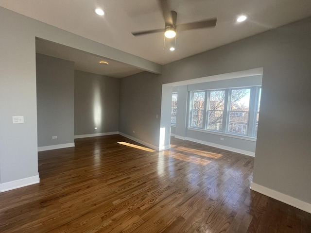 unfurnished room featuring ceiling fan and dark hardwood / wood-style floors