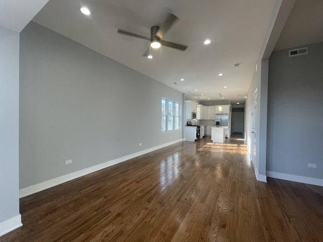 unfurnished living room with dark hardwood / wood-style floors and ceiling fan