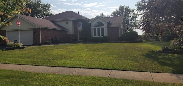 view of front of house with a garage and a front lawn