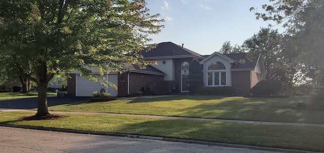 view of front facade with a front lawn and a garage