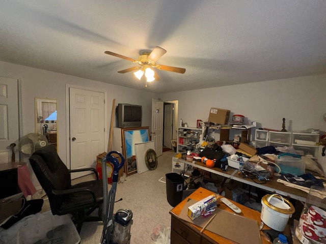 carpeted office space with ceiling fan