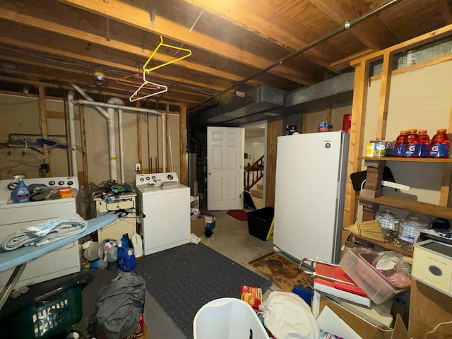 basement with washer / clothes dryer, white fridge, and water heater