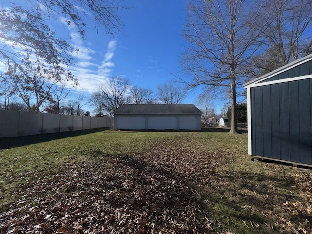 view of yard with a garage and an outdoor structure