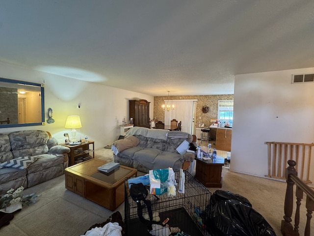 carpeted living room featuring an inviting chandelier