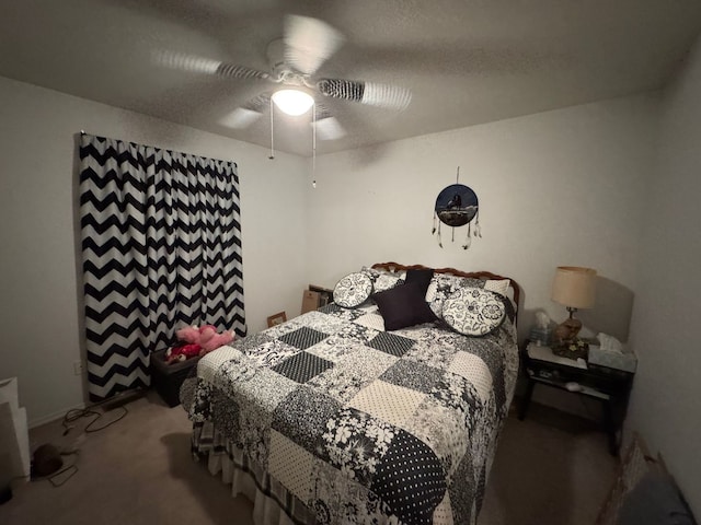 bedroom with a textured ceiling, carpet floors, and ceiling fan