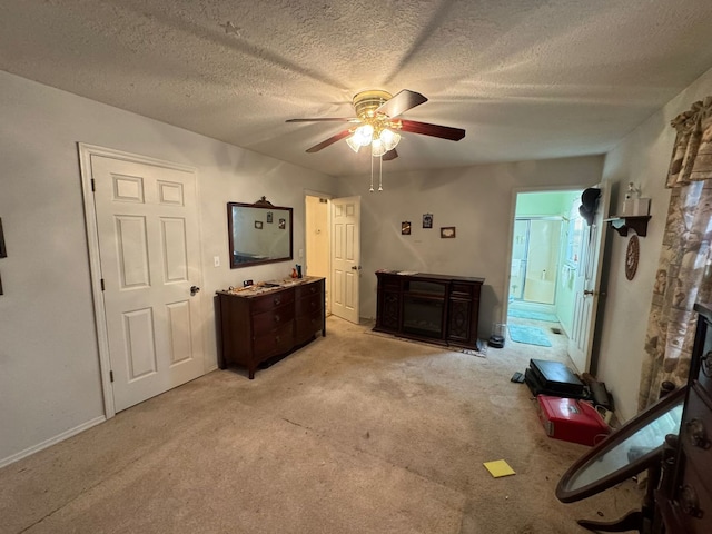 miscellaneous room with light carpet, a textured ceiling, a stone fireplace, and ceiling fan