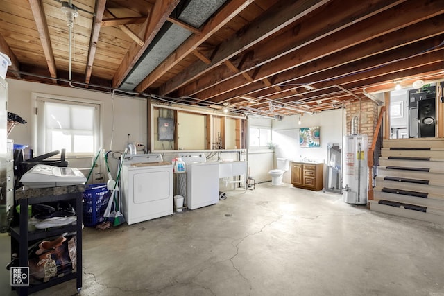 basement with separate washer and dryer, sink, gas water heater, and electric panel