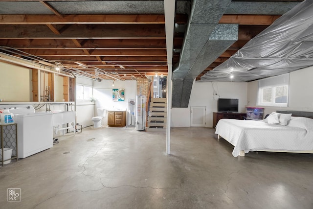 basement with gas water heater and washer and dryer