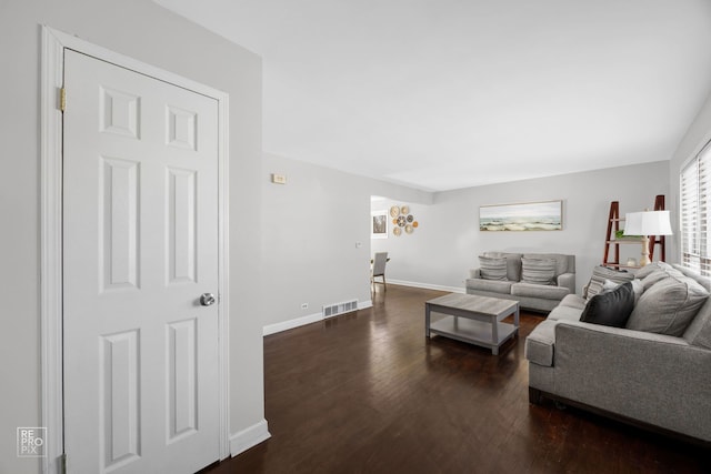 living room featuring dark wood-type flooring