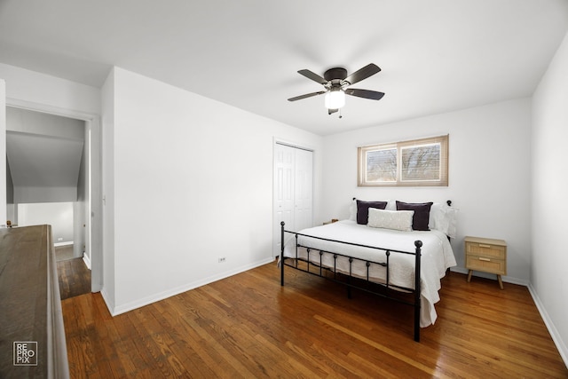 bedroom featuring hardwood / wood-style floors, ceiling fan, and a closet