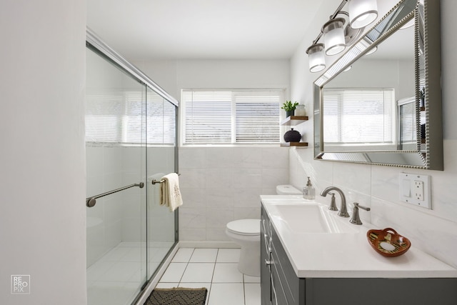 bathroom featuring tile walls, an enclosed shower, vanity, and tile patterned floors