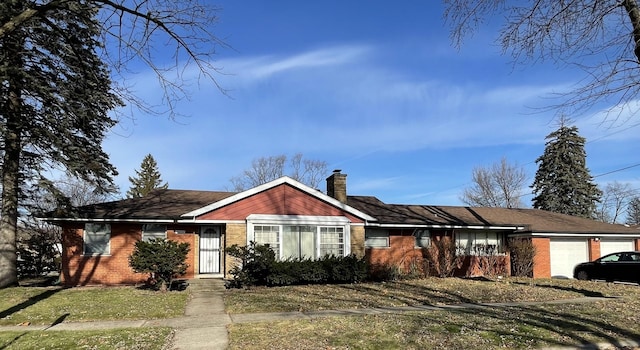 single story home featuring a garage and a front lawn