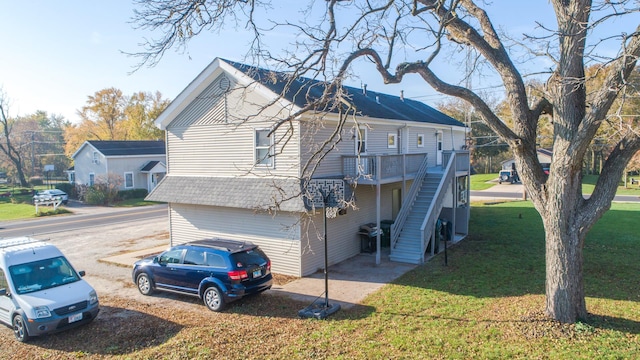 view of side of property featuring a wooden deck and a yard