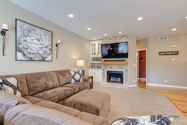 living room with a fireplace and light hardwood / wood-style flooring