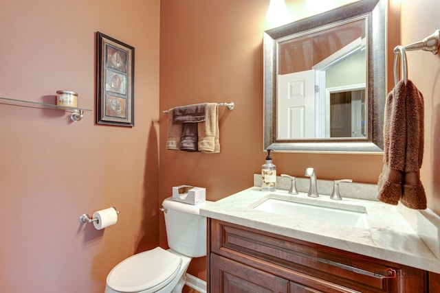 bathroom featuring toilet and vanity