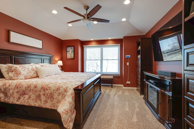 bedroom featuring lofted ceiling, ceiling fan, and light colored carpet