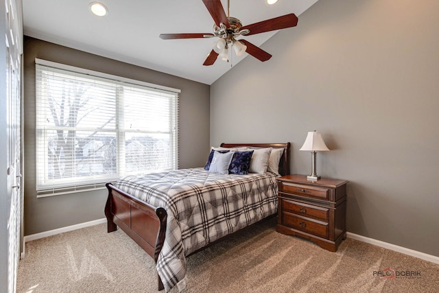 bedroom with vaulted ceiling, ceiling fan, and carpet flooring