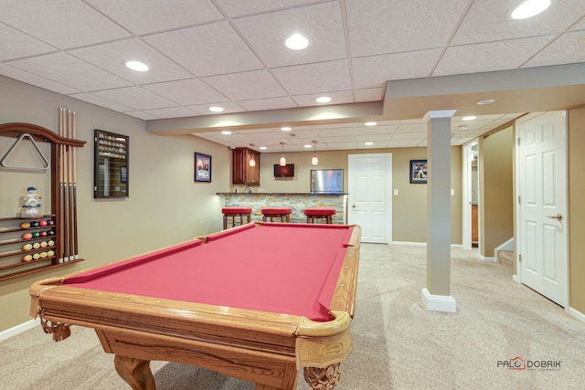 game room with pool table, bar area, a drop ceiling, and light carpet