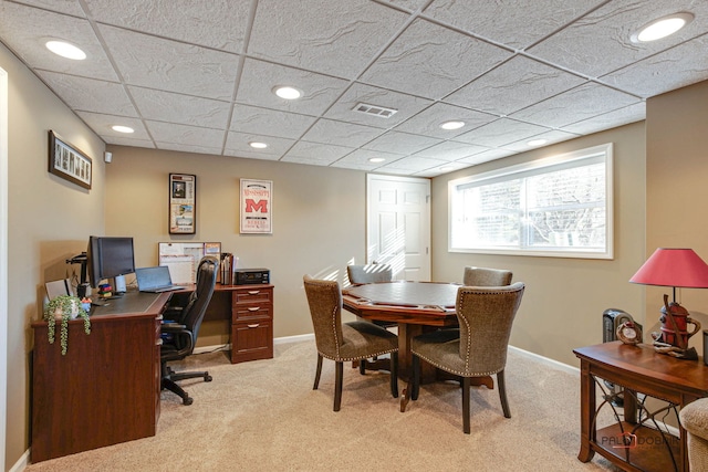 carpeted home office featuring a paneled ceiling