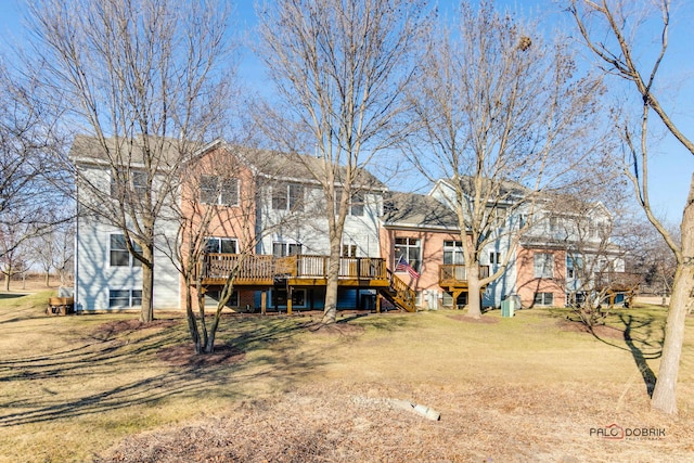 back of house with a yard and a wooden deck