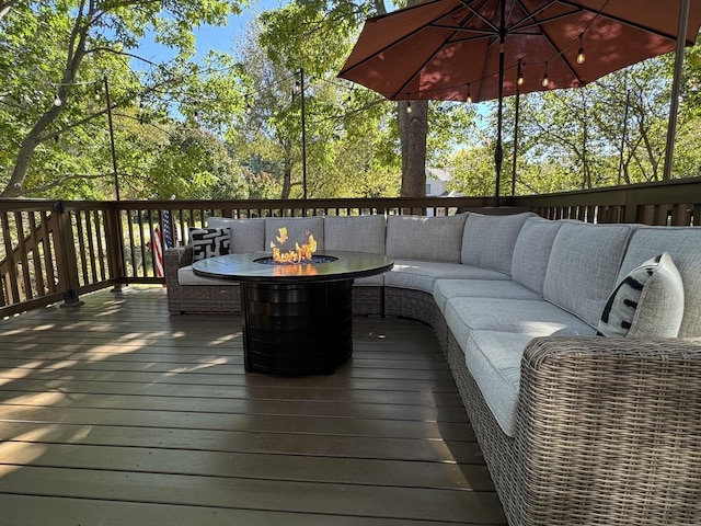 deck with an outdoor living space with a fire pit