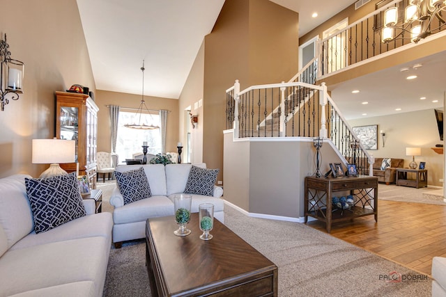 living room with high vaulted ceiling and hardwood / wood-style flooring