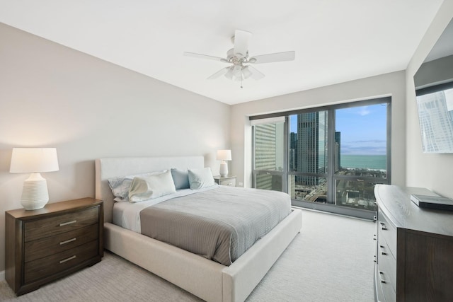 bedroom with light carpet and ceiling fan