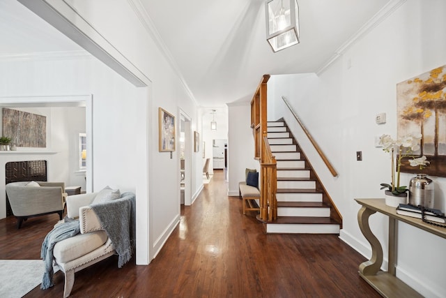 foyer entrance featuring ornamental molding and dark hardwood / wood-style floors