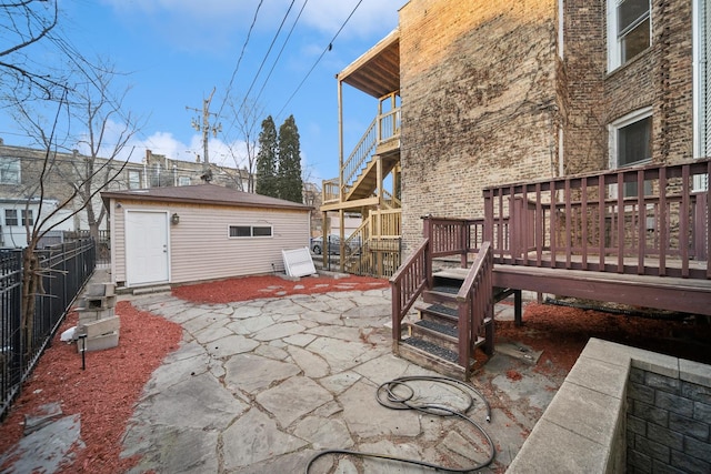 view of patio with a deck and an outdoor structure