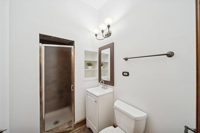 bathroom with a shower with door, toilet, an inviting chandelier, and vanity