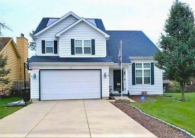 front facade featuring a garage and a front lawn