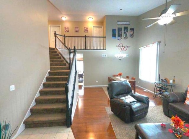 tiled living room with ceiling fan