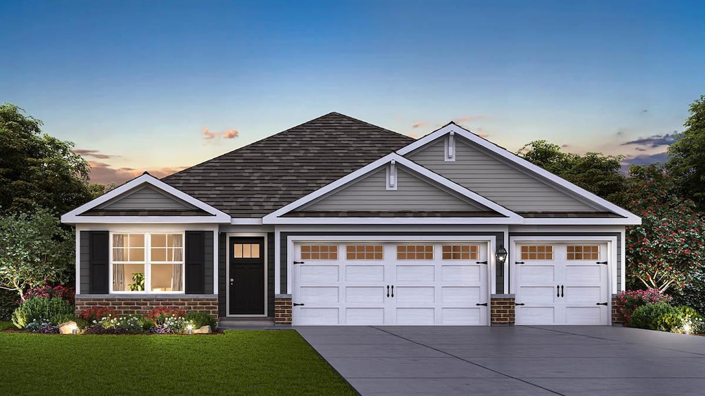 craftsman house featuring a lawn and a garage