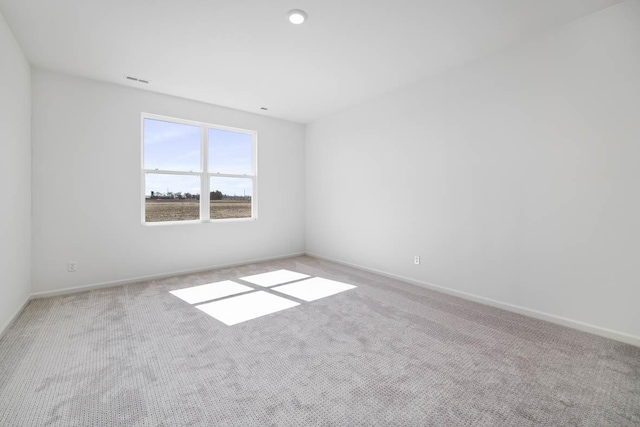 unfurnished room featuring light carpet